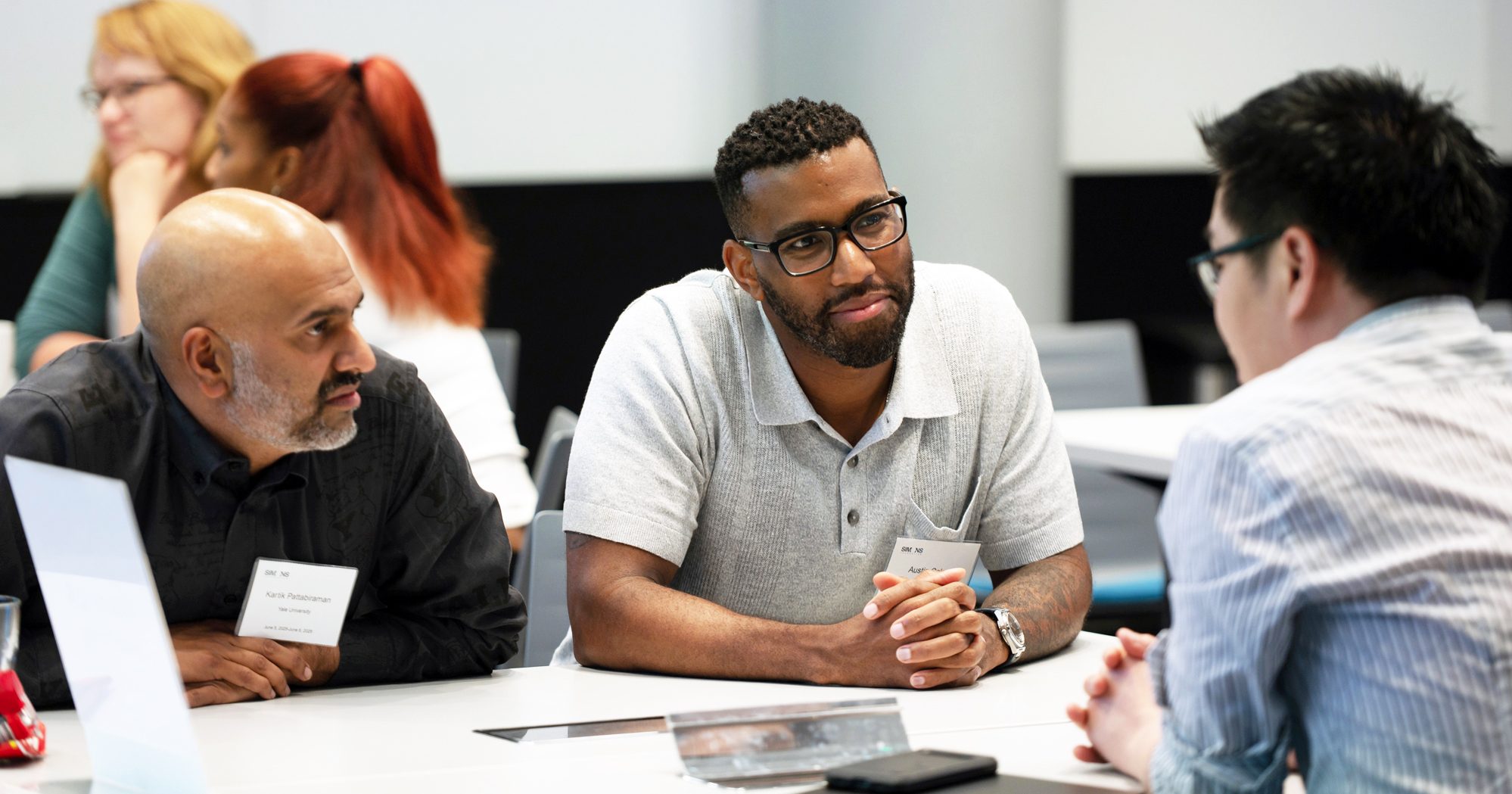 Scientists in a discussion at a table.