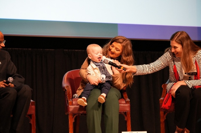 Rebecca Ahrens-Nicklas, M.D., Ph.D., with Nicole Muldoon and her son KJ Muldoon during the gene therapy panel at Rare Disease Day at NIH 2026.